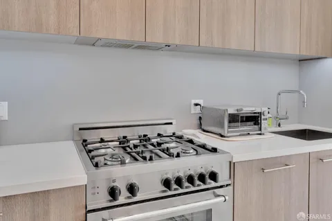 a white stove top oven sitting inside of a kitchen