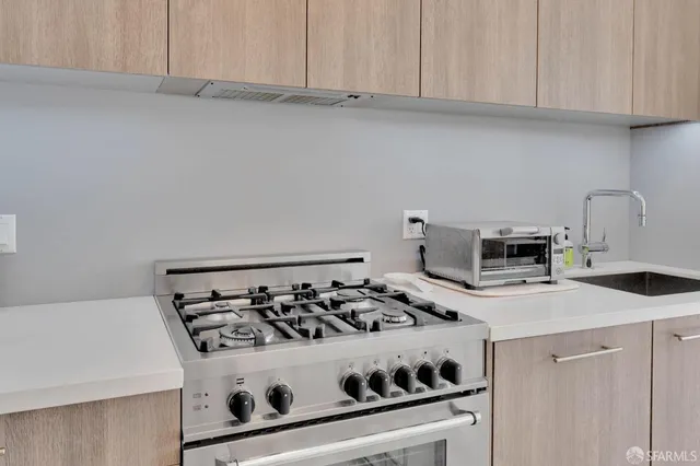 a white stove top oven sitting inside of a kitchen
