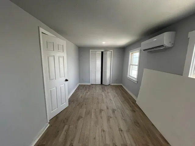 a view of hallway with wooden floor