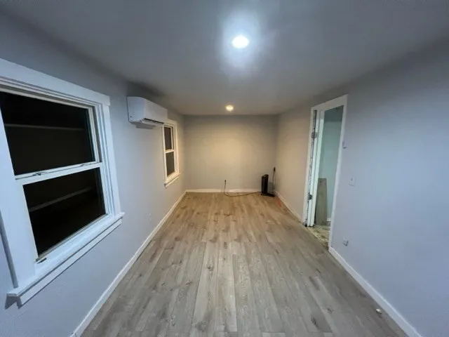 a view of empty room with wooden floor