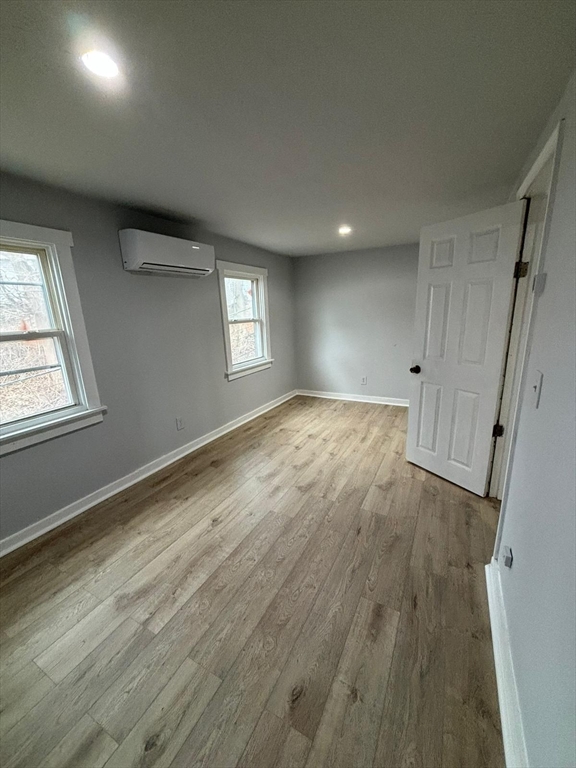 9 Winthrop Street Worcester, MA 01604 - Photo 2 of 30 an empty room with wooden floor and windows