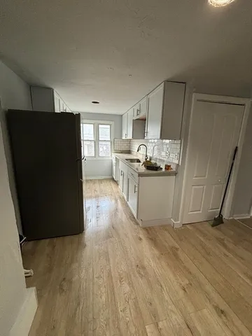 a kitchen with granite countertop a refrigerator and a stove