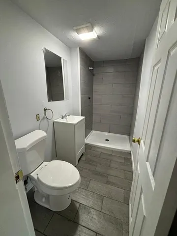 a white toilet sitting next to a bathroom sink