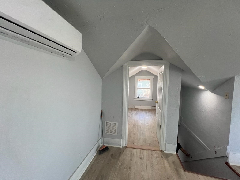 9 Winthrop Street Worcester, MA 01604 - Photo 8 of 30 wooden floor in an empty room with a window