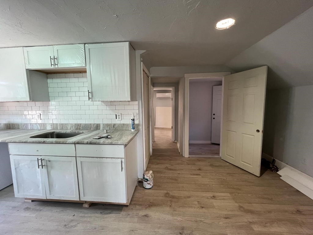 9 Winthrop Street Worcester, MA 01604 - Photo 10 of 30 a kitchen with stainless steel appliances granite countertop a sink stove and cabinets