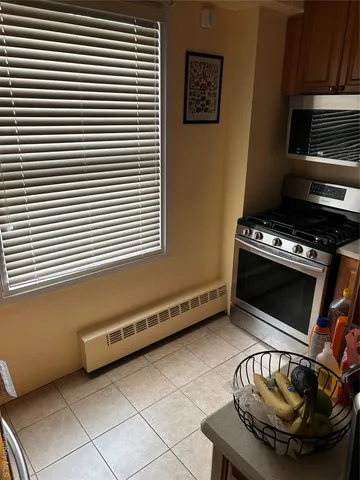 a kitchen with stainless steel appliances a stove a microwave and a sink