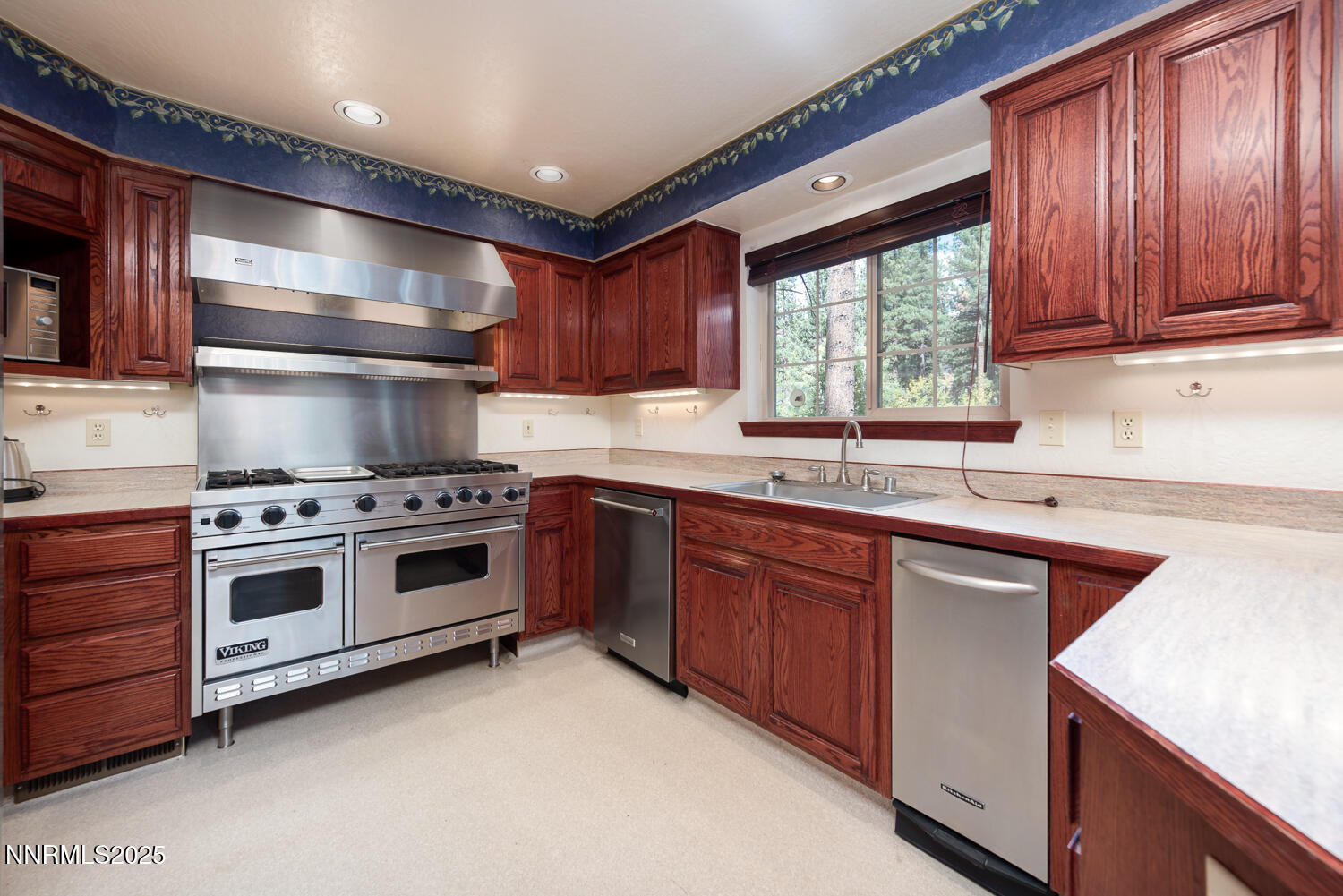 100 Timber Lane Markleeville, CA 96120 - Photo 13 of 29 a kitchen with stainless steel appliances a sink stove and cabinets