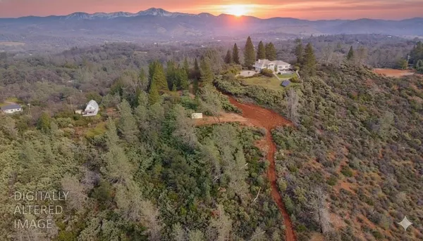 a view of a town with mountains in the background