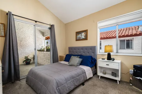 a bedroom with a bed and a painting on the wall