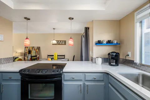 a kitchen with a sink a stove and a refrigerator