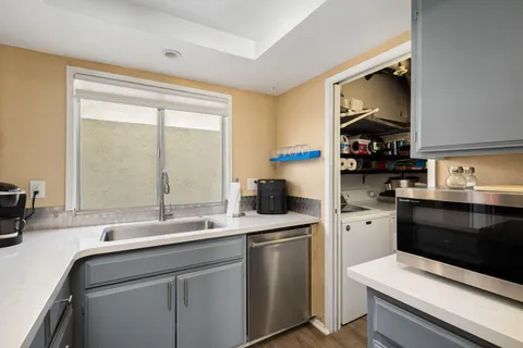 a kitchen with a sink stove and microwave
