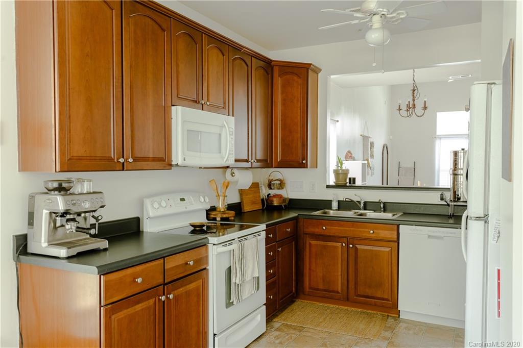 162 Snead Road Fort Mill, SC 29715 - Photo 2 of 25 a kitchen with stainless steel appliances granite countertop a sink a stove cabinets and wooden floor