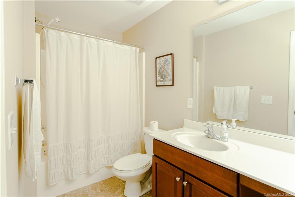 162 Snead Road Fort Mill, SC 29715 - Photo 23 of 25 a bathroom with a sink toilet a mirror and shower curtain
