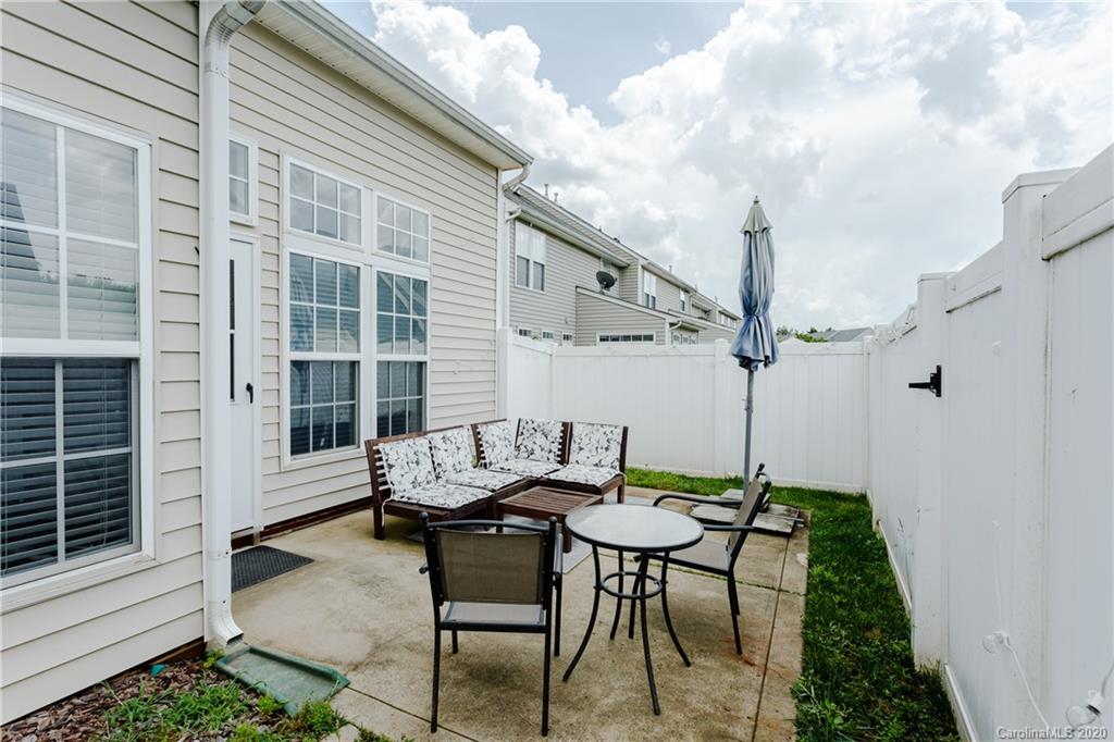 162 Snead Road Fort Mill, SC 29715 - Photo 24 of 25 a view of a patio with table and chairs and wooden floor