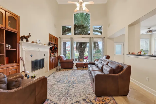 a living room with furniture a fireplace and a chandelier