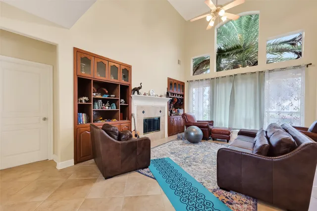 a living room with furniture fireplace and a window