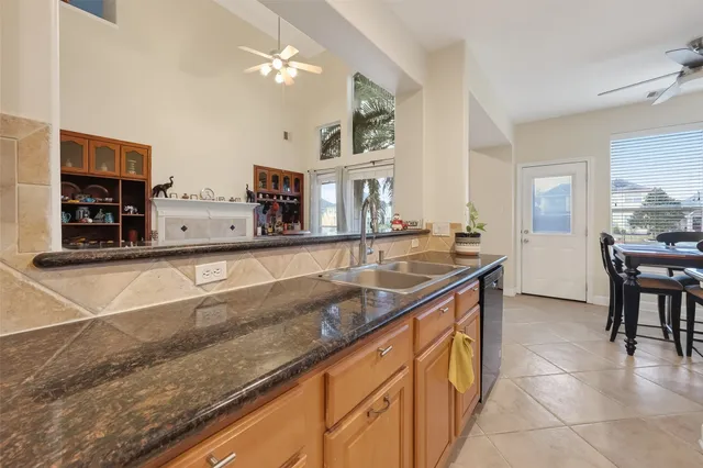 a kitchen with stainless steel appliances granite countertop a sink and a counter top space