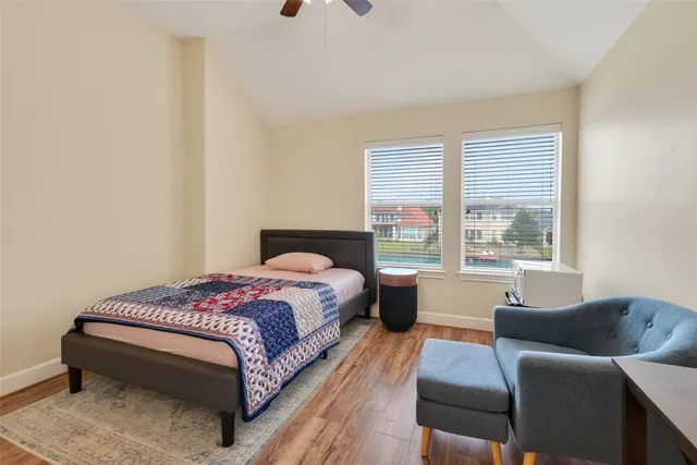 a bedroom with a bed and a couch with window