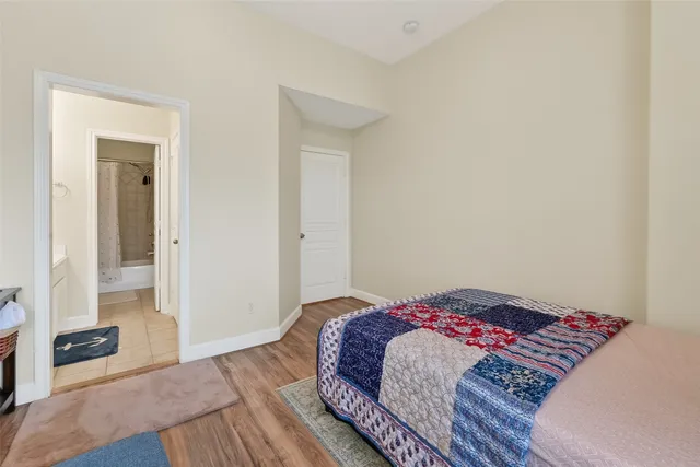 a bedroom with a bed and a mirror