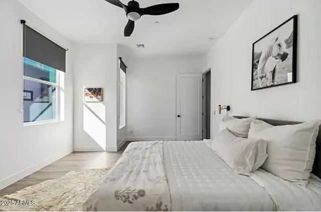 a bedroom with a bed and a potted plant