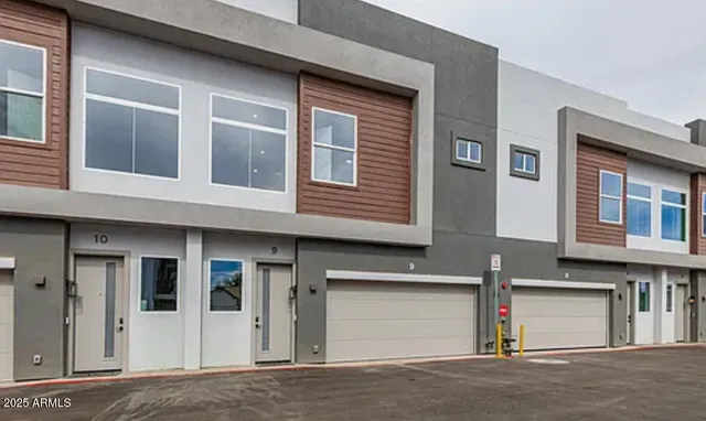 a front view of residential houses with road