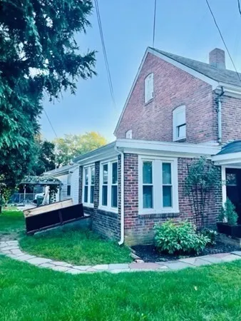 a view of a house with a backyard