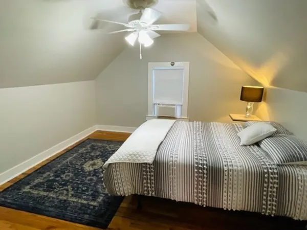a bedroom with a bed and a ceiling fan