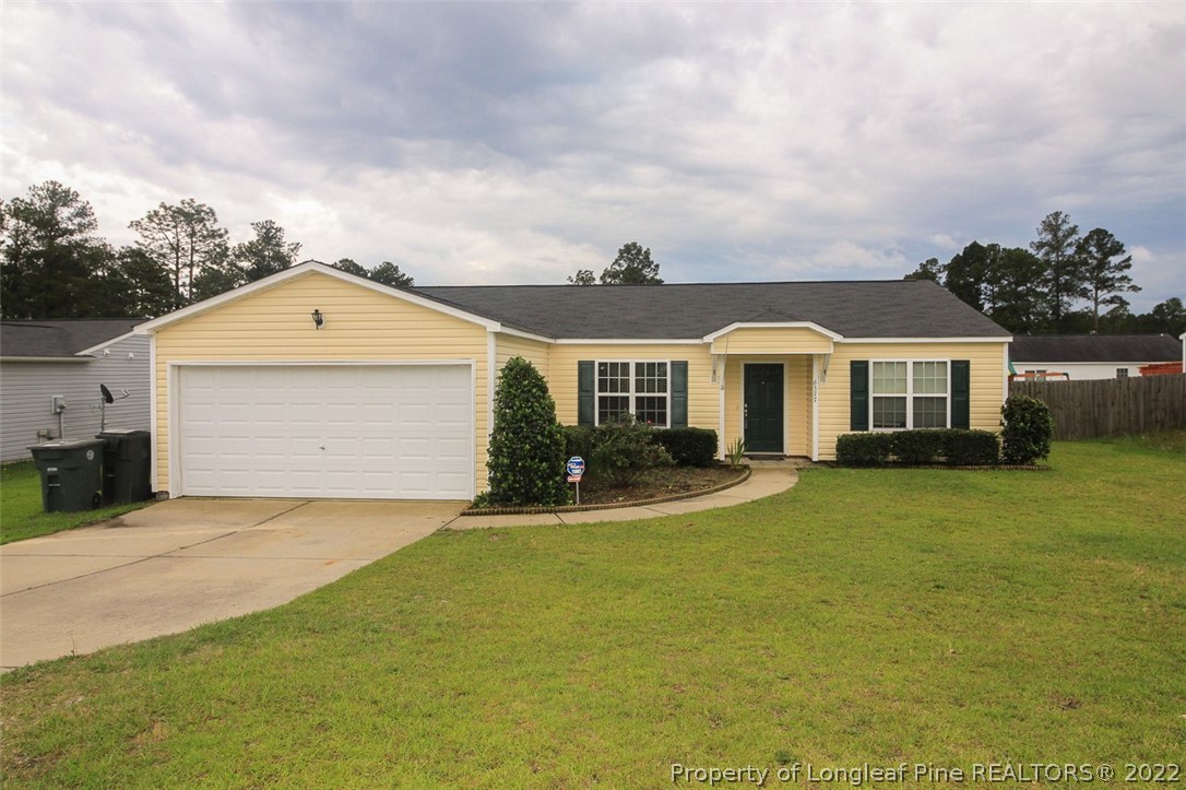 6377 Overhills Road Spring Lake, NC 28390 - Photo 1 of 29 a front view of a house with a garden and yard