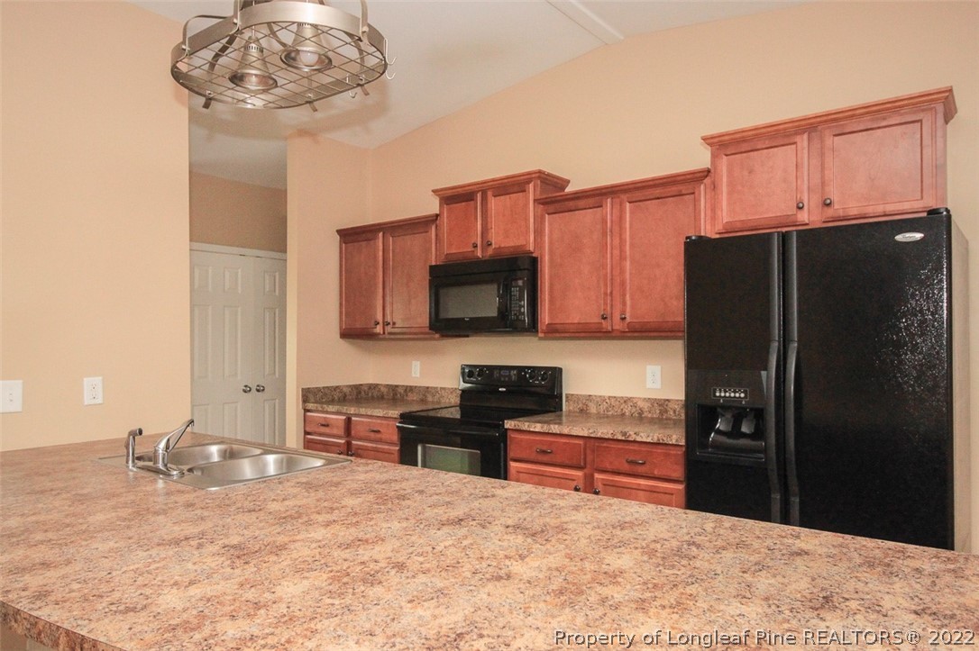 6377 Overhills Road Spring Lake, NC 28390 - Photo 11 of 29 a kitchen with a refrigerator and a sink
