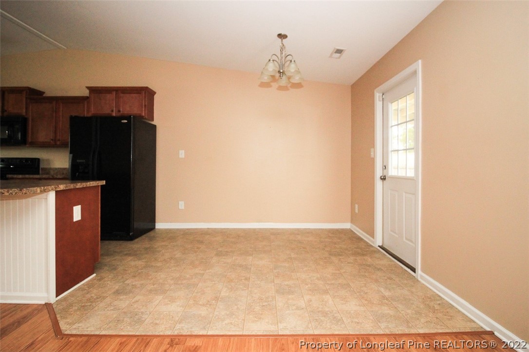 6377 Overhills Road Spring Lake, NC 28390 - Photo 12 of 29 a view of a kitchen with wooden cabinets
