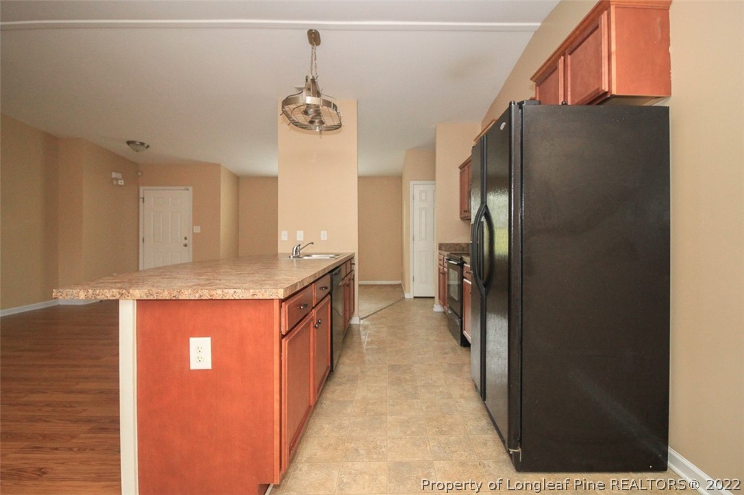 6377 Overhills Road Spring Lake, NC 28390 - Photo 13 of 29 a kitchen with stainless steel appliances granite countertop a refrigerator a sink and a stove