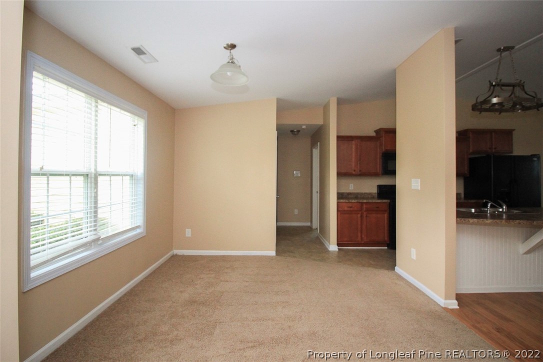 6377 Overhills Road Spring Lake, NC 28390 - Photo 15 of 29 a view of a kitchen and an empty room and kitchen space with a window