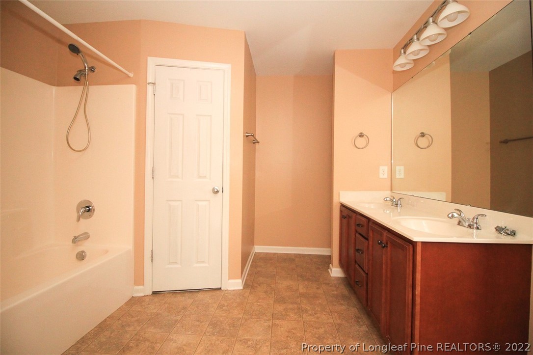6377 Overhills Road Spring Lake, NC 28390 - Photo 18 of 29 a bathroom with a shower sink and mirror