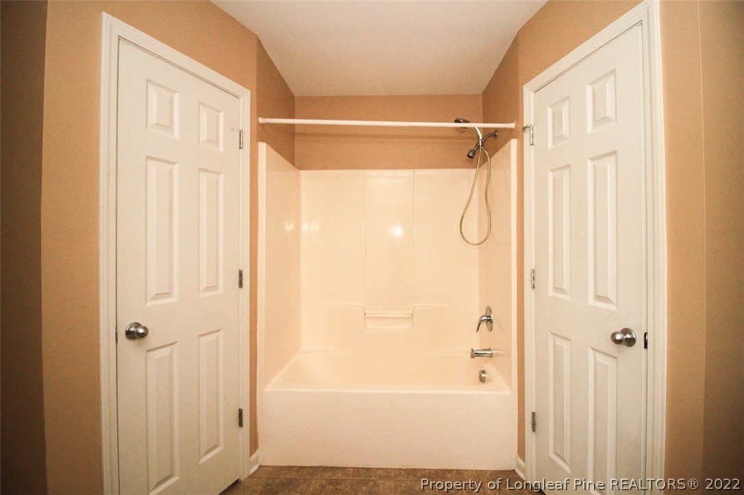6377 Overhills Road Spring Lake, NC 28390 - Photo 19 of 29 a bathroom with a glass shower door