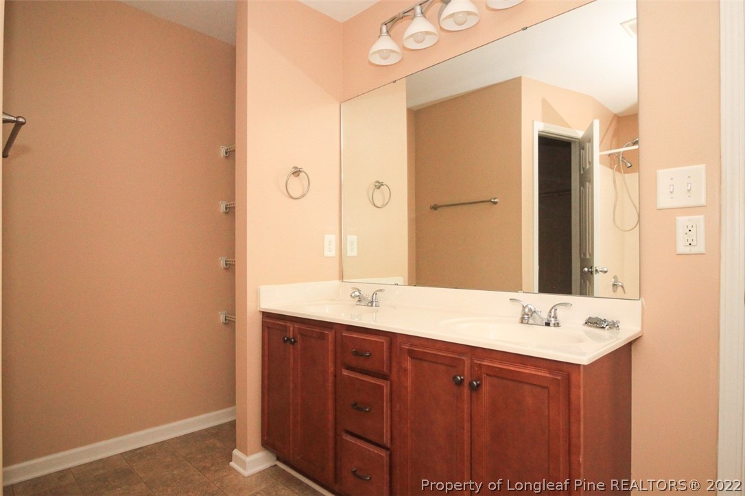 6377 Overhills Road Spring Lake, NC 28390 - Photo 20 of 29 a bathroom with a double vanity sink and mirror