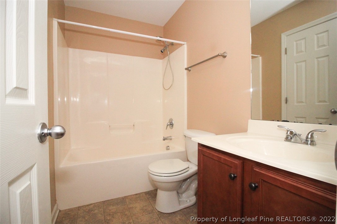 6377 Overhills Road Spring Lake, NC 28390 - Photo 24 of 29 a bathroom with a sink a toilet and shower