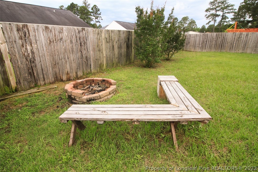 6377 Overhills Road Spring Lake, NC 28390 - Photo 27 of 29 a wooden bench sitting in the middle of a park