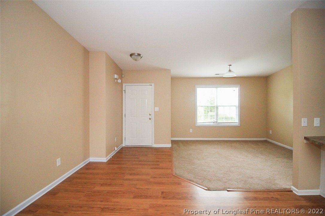 6377 Overhills Road Spring Lake, NC 28390 - Photo 4 of 29 an empty room with wooden floor and windows