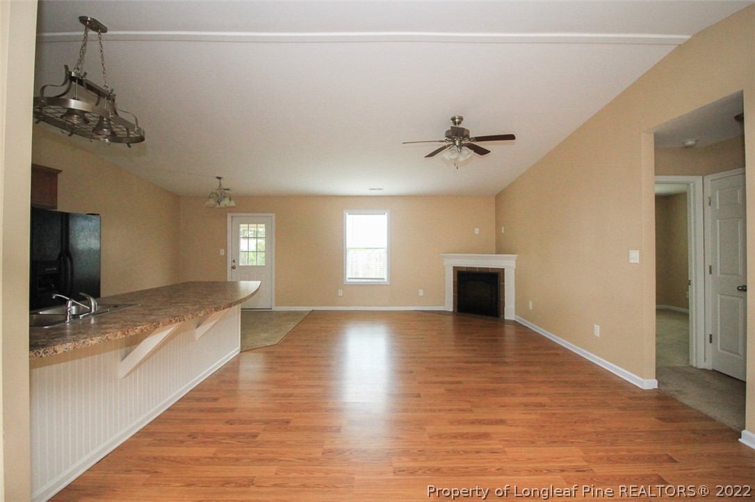 6377 Overhills Road Spring Lake, NC 28390 - Photo 6 of 29 a view of an empty room with window and wooden floor
