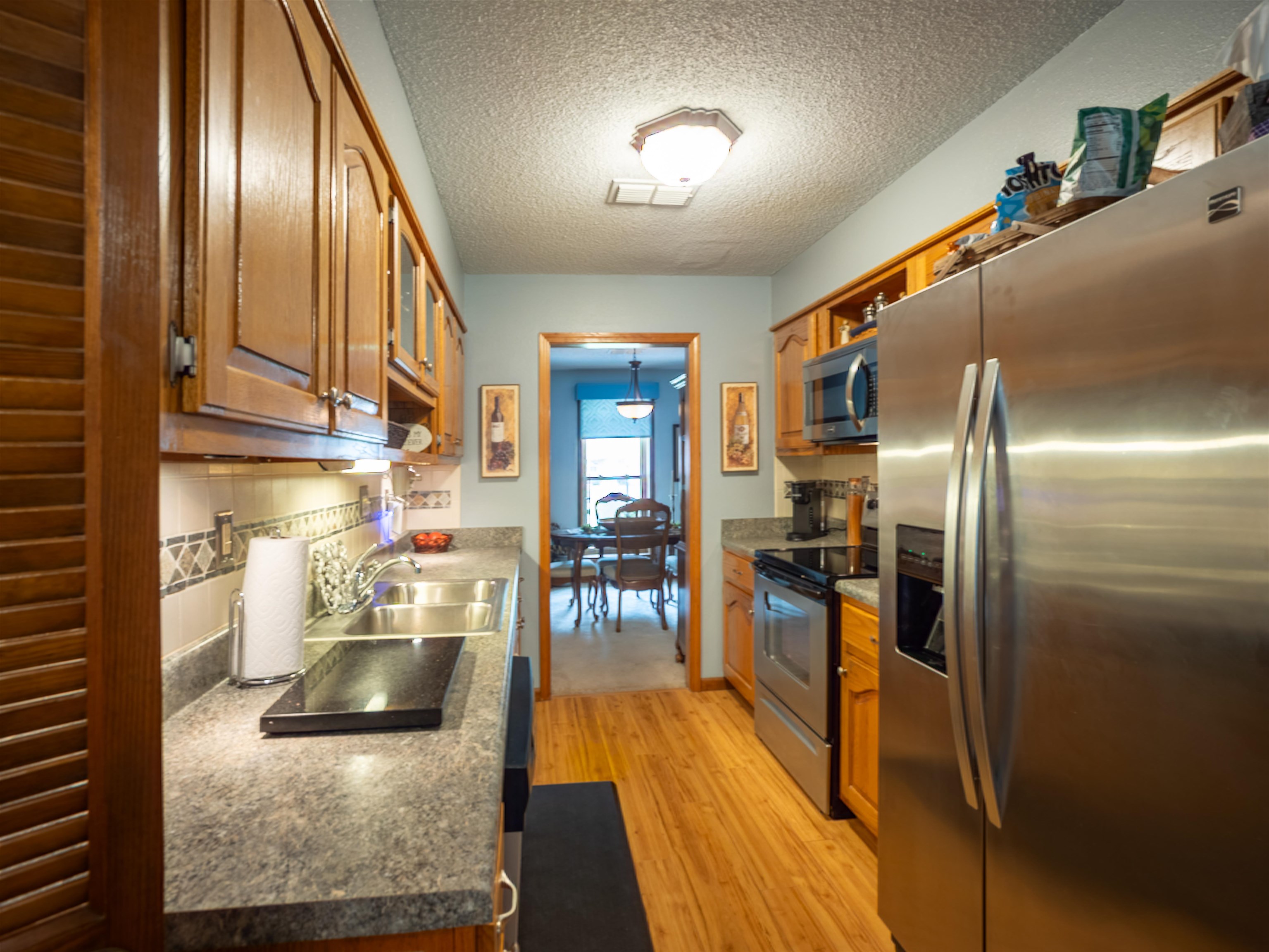 65 Paulette Circle Covington, TN 38019 - Photo 13 of 33 a kitchen with stainless steel appliances granite countertop a refrigerator a stove and a wooden floors