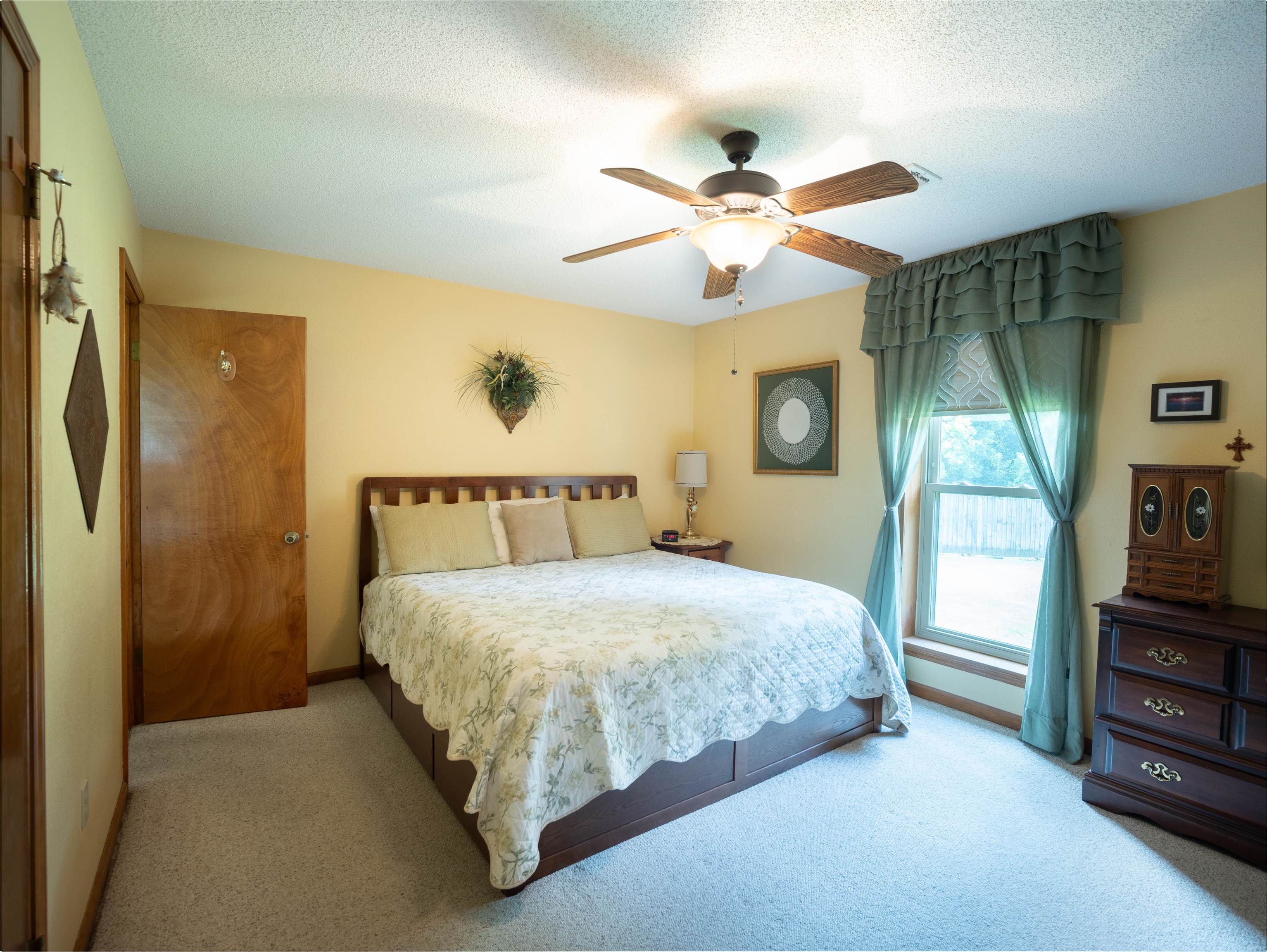 65 Paulette Circle Covington, TN 38019 - Photo 18 of 33 a spacious bedroom with a bed and a painting on the wall