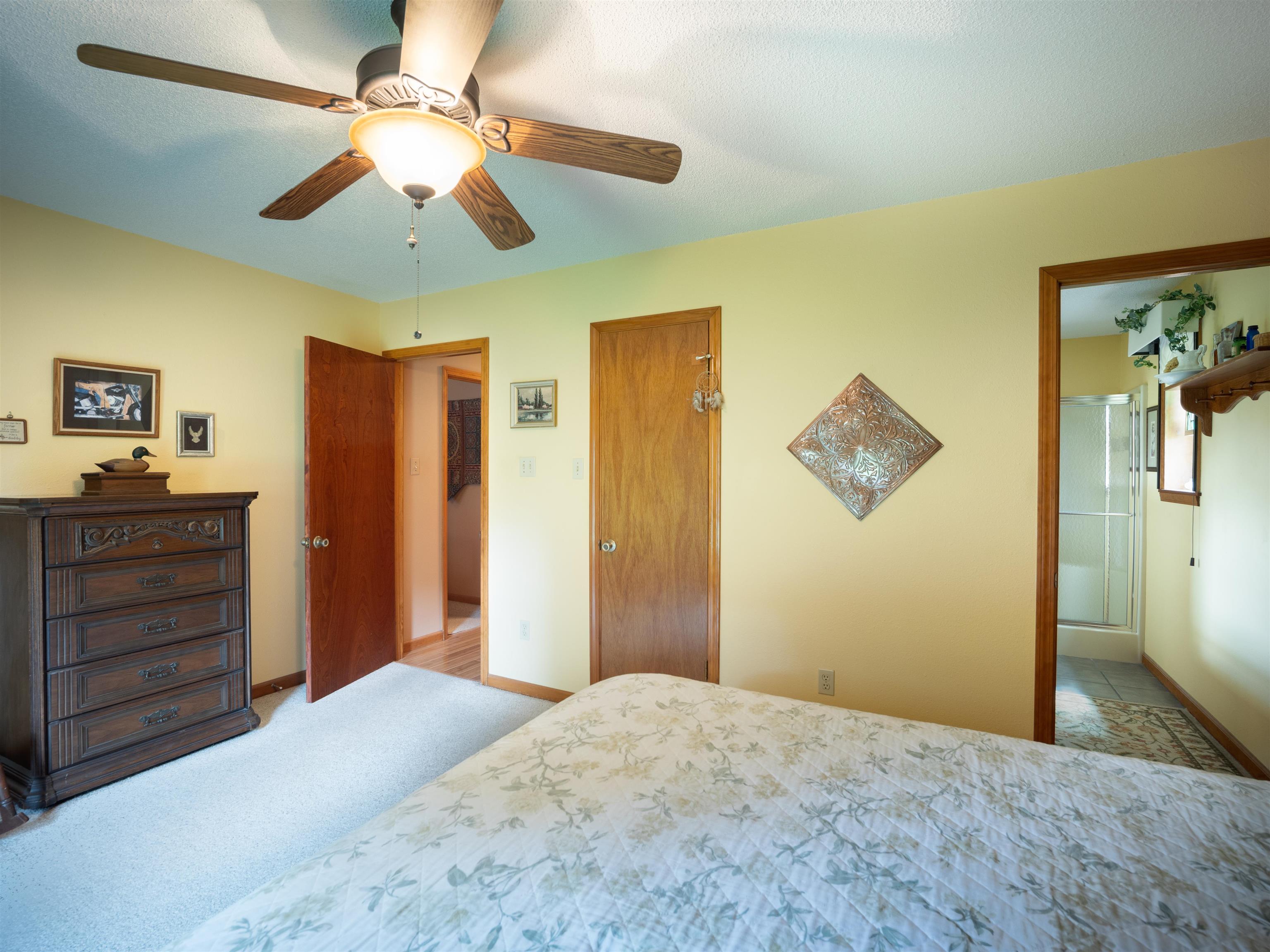 65 Paulette Circle Covington, TN 38019 - Photo 19 of 33 a bedroom with a bed and a chandelier