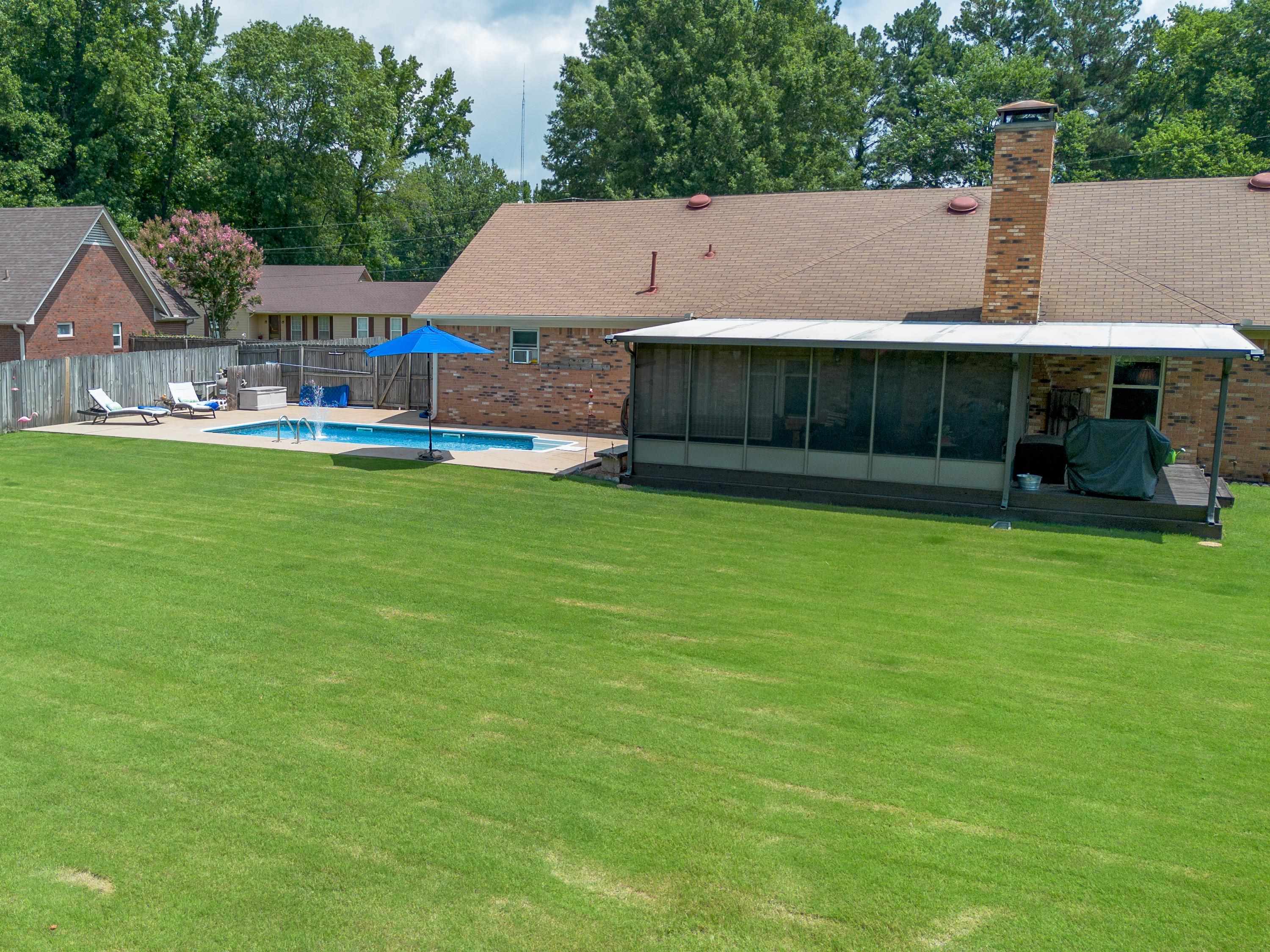 65 Paulette Circle Covington, TN 38019 - Photo 6 of 33 a view of a patio with a table and chairs under an umbrella
