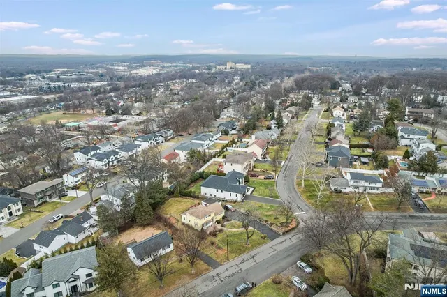 an aerial view of residential houses with city view
