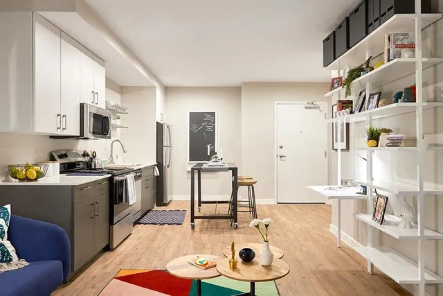 a kitchen with a refrigerator a stove top oven a sink and dishwasher