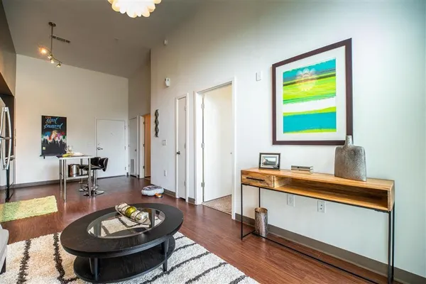 a living room with lots of furniture and a large window