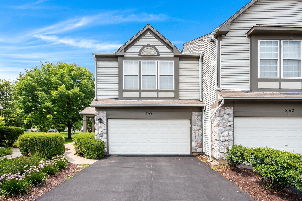 a front view of a house with a garage