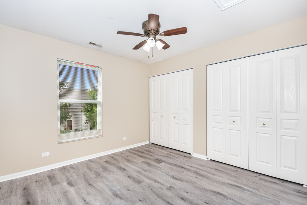 3160 Bromley Lane Aurora, IL 60502 - Photo 11 of 15 wooden floor in an empty room with a window