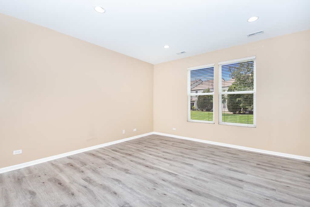 3160 Bromley Lane Aurora, IL 60502 - Photo 12 of 15 an empty room with wooden floor and windows