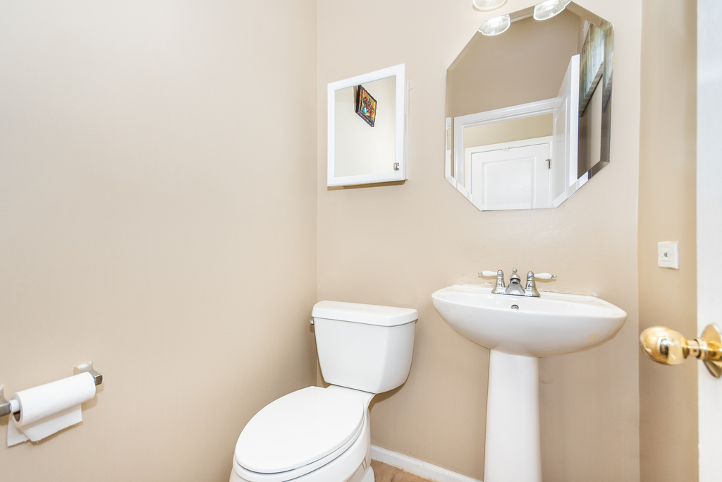 3160 Bromley Lane Aurora, IL 60502 - Photo 14 of 15 a bathroom with a toilet sink and mirror